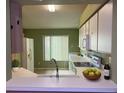 Bright kitchen with white cabinets, modern appliances, and a breakfast bar, perfect for casual dining and entertaining at 12139 Buffington Ln, Riverview, FL 33579