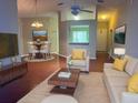 Cozy living room with modern furniture, hardwood floors, and neutral tones creating a welcoming and stylish atmosphere at 12139 Buffington Ln, Riverview, FL 33579