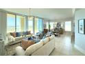 Bright living room featuring elegant furnishings, large windows, and scenic views at 130 Riviera Dunes Way # 606, Palmetto, FL 34221