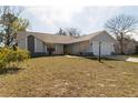 Inviting single-Gathering home with a well-maintained lawn and a convenient two-car garage, bathed in natural light at 13305 Whitby Rd, Hudson, FL 34667
