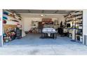 Well-organized garage space with custom shelves and storage, offering ample room for a car and tools at 13305 Whitby Rd, Hudson, FL 34667