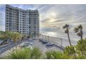 A beachfront condo building offers ocean views, lush palms, and ample parking at 1600 Gulf Blvd # 512, Clearwater, FL 33767