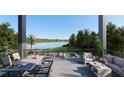 Stunning outdoor space with lake view, dining area and comfy seating for relaxing and entertaining at 1870 Stevenson Ave, Clearwater, FL 33755
