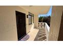 Private outdoor entryway showcasing a secure entrance door and views of mature landscaping at 2612 Pearce Dr # 211, Clearwater, FL 33764