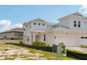 Charming townhome features a two-car garage and neutral color scheme with simple landscaping at 31857 Anchor Point Dr, Wesley Chapel, FL 33545