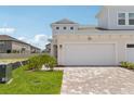 Charming townhome features a two-car garage and neutral color scheme with well maintained landscaping at 31857 Anchor Point Dr, Wesley Chapel, FL 33545