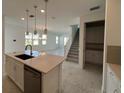 Open-concept kitchen with a center island, stainless steel appliances, and adjacent living area at 31857 Anchor Point Dr, Wesley Chapel, FL 33545