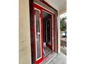 Close up of a new construction home's red-framed front door, viewed from the exterior at 3413 N 72Nd St, Tampa, FL 33619