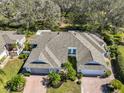 Stunning aerial view of the home highlighting its roof, landscaping, and proximity to lush trees at 658 Masterpiece Dr # 186, Sun City Center, FL 33573