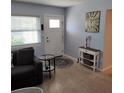 Inviting living room featuring neutral walls, front door, and comfortable seating at 675 Marjon Ave, Dunedin, FL 34698