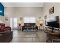 Spacious living room featuring high ceilings, tile flooring, and comfortable leather seating arrangement at 720 Gasparino Ct, Seffner, FL 33584