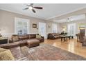 Spacious living room featuring hardwood floors, large windows, ceiling fans, and comfortable seating at 732 Oak Ne St, St Petersburg, FL 33701