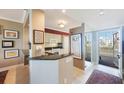 Open kitchen with granite countertops, white cabinets and stainless appliances at 7892 Sailboat Key S Blvd # 107, South Pasadena, FL 33707