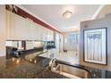 Cozy kitchen featuring dark granite counters and white appliances at 7892 Sailboat Key S Blvd # 107, South Pasadena, FL 33707