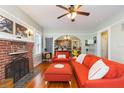 Inviting living room boasting hardwood floors, a fireplace, comfortable seating, and stylish decor at 907 E Hamilton Ave, Tampa, FL 33604