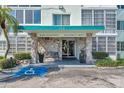 Inviting condo building featuring rock facade, well-manicured landscaping and an accessible entrance at 100 Waverly Way # 101, Clearwater, FL 33756