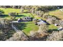 Expansive property featuring a charming home, lush green pastures, and a well-maintained barn at 10946 Gun Dog Way, Lithia, FL 33547