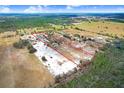 Aerial view of a large property outlined in red, showcasing land and surrounding greenery at 11050 Revell Rd, Duette, FL 34219