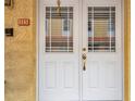 Inviting front door with sidelights, a decorative golden handle and clear address numbers for easy visibility at 11555 Gulf Blvd Blvd # 115, Treasure Island, FL 33706