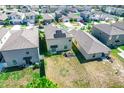 Aerial view of a home featuring a solar panel installation with a spacious backyard at 14430 English Lavender Dr, Wimauma, FL 33598