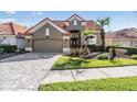 Charming single-Gathering home boasting a red tile roof, desert landscaping and a paved driveway at 18823 Avenue Biarritz, Lutz, FL 33558