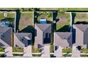Aerial view of home showing solar panels, fenced yard, and proximity to neighbors at 197 Rain Berry Ave, Ruskin, FL 33570