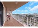 Spacious balcony featuring brick flooring and comfortable seating with scenic city views at 223 Island Way # 7H, Clearwater, FL 33767