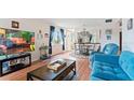 A comfortable living room with a large television and a view into the dining area at 2370 Jamaican St # 30, Clearwater, FL 33763