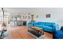 A cozy living room with bright laminated floors and comfortable blue furniture at 2370 Jamaican St # 30, Clearwater, FL 33763