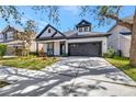 Inviting home showcasing a lush lawn, attractive black trim, and a practical attached two-car garage at 3510 Brook Crossing Dr, Brandon, FL 33511
