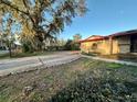 Charming single-story home with mature landscaping in the front yard, providing ample shade and curb appeal at 3521 Sumner Rd, Dover, FL 33527