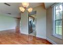 Open dining area with hardwood floors leading to a kitchen with stainless steel appliances at 4908 Lynchburg Ct, New Port Richey, FL 34655