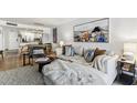 Inviting living room with couch, open to kitchen and dining areas, and hardwood flooring at 620 Edgewater Dr # 204, Dunedin, FL 34698
