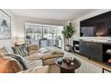 Comfortable living room with couch, tv, table, bar area, and large windows with natural light at 620 Edgewater Dr # 204, Dunedin, FL 34698