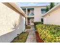 Well-maintained condo building featuring pleasant landscaping and inviting walkways at 6311 99Th N Way # 11B, St Petersburg, FL 33708