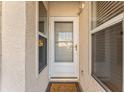 Inviting front door with sidelight windows and a 'Welcome' mat, adding charm to the home's entrance at 6311 99Th N Way # 11B, St Petersburg, FL 33708