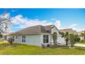 Well-maintained home with lush lawn, showcasing landscaping and architectural features at 7541 Mariners Harbour Dr, Wesley Chapel, FL 33545