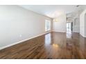 Bright living room with beautiful hardwood flooring, chandelier, and large window at 7541 Mariners Harbour Dr, Wesley Chapel, FL 33545