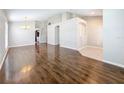 Open-concept living area featuring hardwood floors and decorative archways into other rooms at 7541 Mariners Harbour Dr, Wesley Chapel, FL 33545