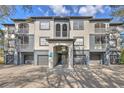 Condominium building with attached garages and staircase entrance at 13304 Sanctuary Cove Dr # 303, Temple Terrace, FL 33637