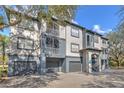 Condominium exterior featuring attached garages and staircase access at 13304 Sanctuary Cove Dr # 303, Temple Terrace, FL 33637