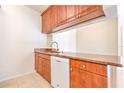 Kitchen area featuring wooden cabinets, and granite countertops at 13304 Sanctuary Cove Dr # 303, Temple Terrace, FL 33637