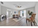 Inviting living room with hardwood floors, neutral decor, and sliding glass doors to the balcony at 1142 84Th N Ter # C, St Petersburg, FL 33702