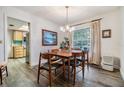Charming dining room with wood flooring, a modern light fixture, and ample natural light at 1421 Monte Carlo Dr, Clearwater, FL 33764