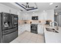 Modern kitchen featuring white cabinets, stainless steel appliances, and stylish countertops at 150 Belleview Blvd # 307, Belleair, FL 33756