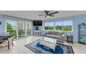 Comfortable living room with large windows offering beautiful views of the water at 150 Belleview Blvd # 307, Belleair, FL 33756