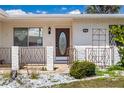 Inviting front porch with a decorated white brick wall, a scrolled iron gate, and a beautiful door at 1517 Danbury Dr, Sun City Center, FL 33573