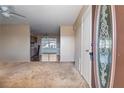 Bright living room features neutral walls, carpeted floors, and a view into the kitchen at 1517 Danbury Dr, Sun City Center, FL 33573