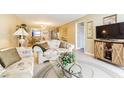 Inviting living room with tile floors, a comfortable sofa, and stylish decor at 1750 Belleair Forest Dr # A7, Belleair, FL 33756