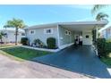 Inviting single-story home with a covered carport and decorative landscaping at 18675 Us Highway 19 N # 251, Clearwater, FL 33764